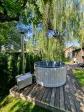 Home garden jacuzzi with hydromassage with a wood fireplace, arrangement on the terrace